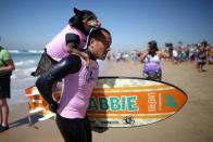 <p>A dog is carried up the beach after competing in the Surf City Surf Dog competition in Huntington Beach, California, U.S., September 25, 2016. REUTERS/Lucy Nicholson</p>