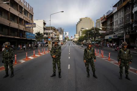 Thai soldiers stand guard along roads blocked around the Victory Monument, where anti-coup protesters were gathering on previous days, in Bangkok May 30, 2014. REUTERS/Athit Perawongmetha