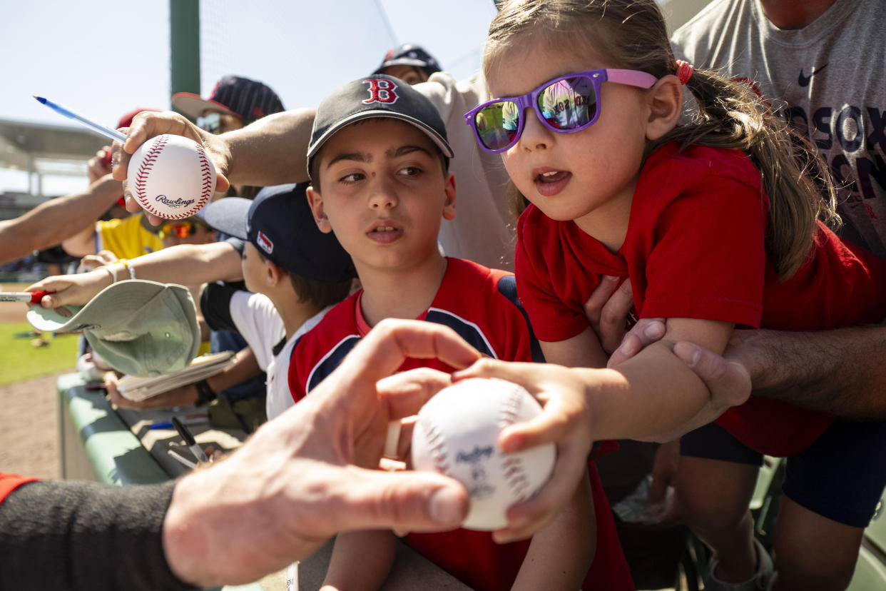 Young fans receive autographs before a Red Sox-Twins spring training game. (Billie Weiss/Boston Red Sox/Getty Images)