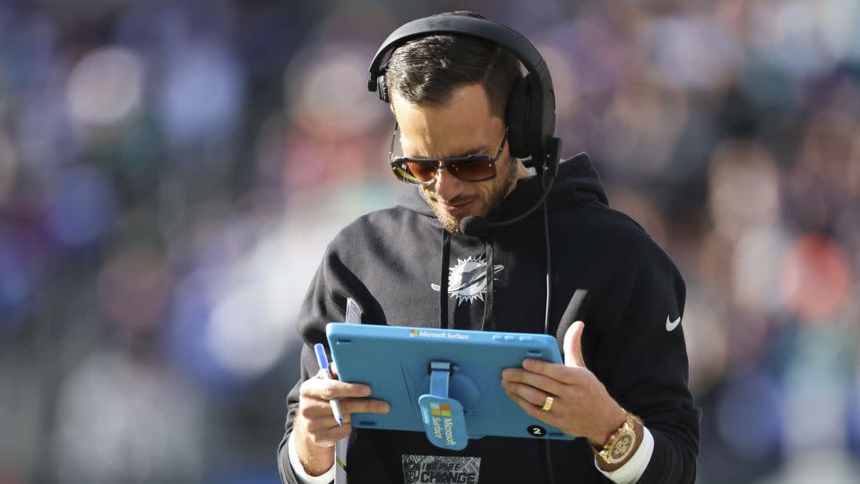 McDaniel looks at his play sheet during the first half of the game against the Ravens. - Rob Carr/Getty Images