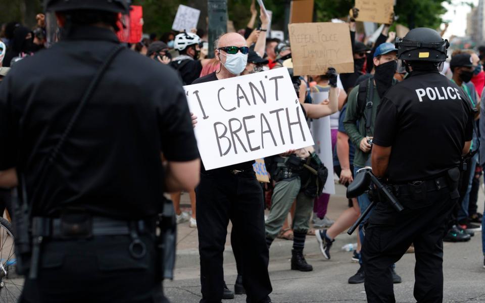 A protester in Denver  - AP