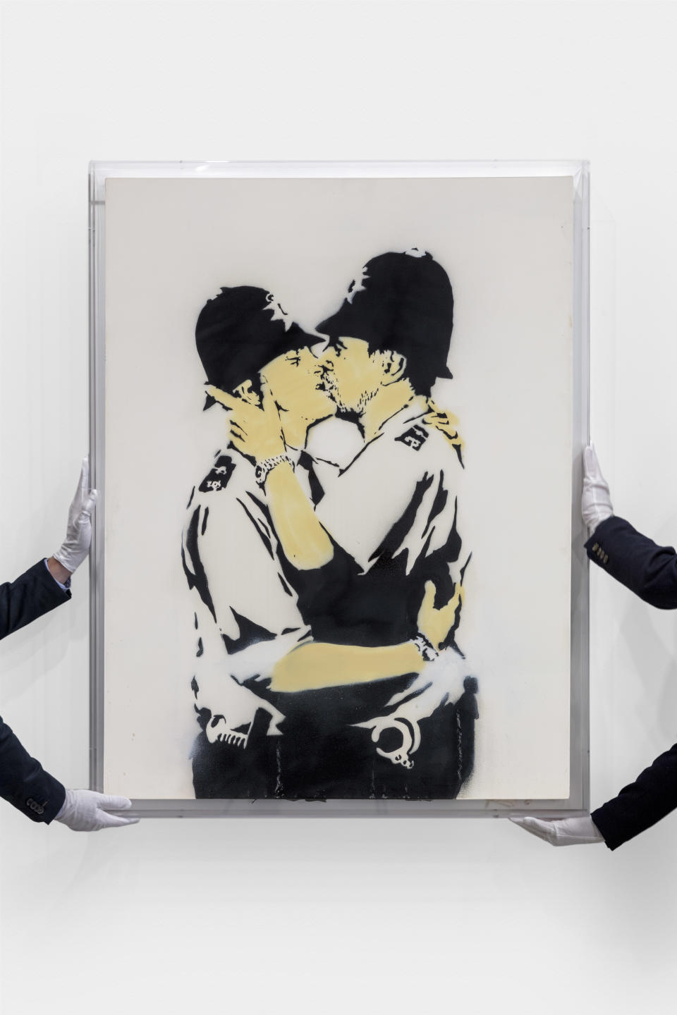 Kissing Coppers by Banksy (Joshua White/Sotheby’s/PA)