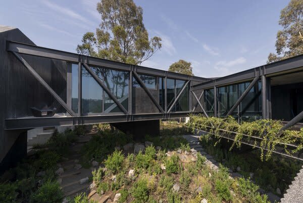 Floor-to-ceiling glazing lines the walls of the main living areas overlooking the garden.