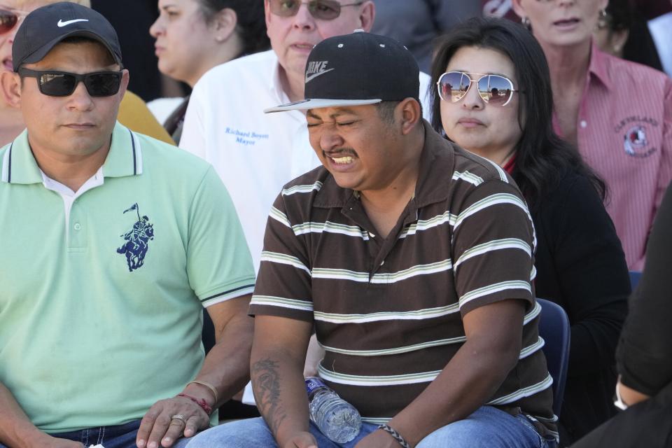 Mass shooting survivor Wilson Garcia becomes emotional during a vigil for his son, Daniel Enrique Laso, Sunday, April 30, 2023, in Cleveland, Texas. Garcia's son and wife were killed in the shooting Friday night. The search for a Texas man who allegedly shot his neighbors after they asked him to stop firing off rounds in his yard stretched into a second day Sunday, with authorities saying the man could be anywhere by now. The suspect fled after the shooting Friday night that left multiple people dead, including the young boy. (AP Photo/David J. Phillip)