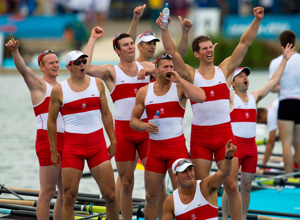 Canada's men's eight rowing team members celebrate their silver medal at Eton Dorney