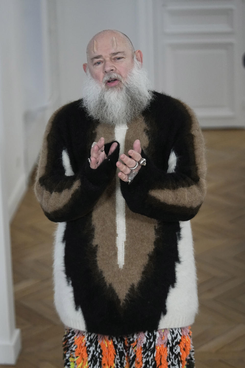 Designer Walter van Beirendonck applauds after the presentation of his Menswear ready-to-wear Fall-Winter 2024-2025 collection in Paris Wednesday, Jan. 17, 2024 in Paris. (AP Photo/Michel Euler)