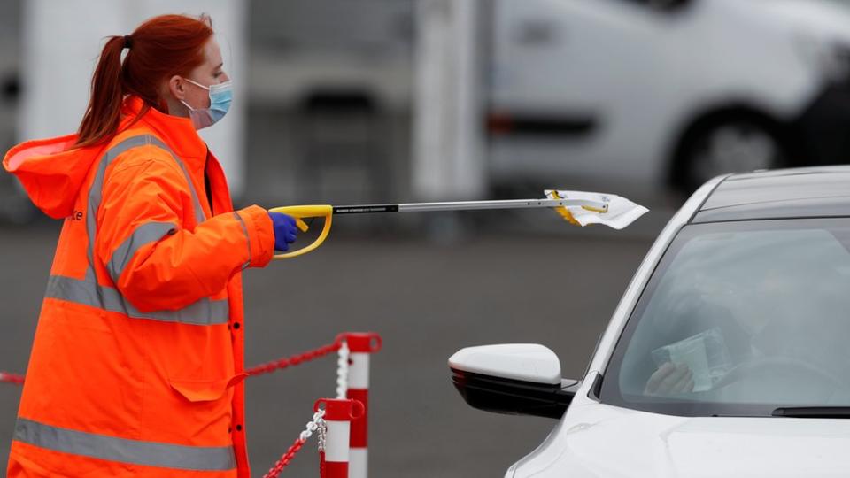 A woman collecting a PCR test in Bedford