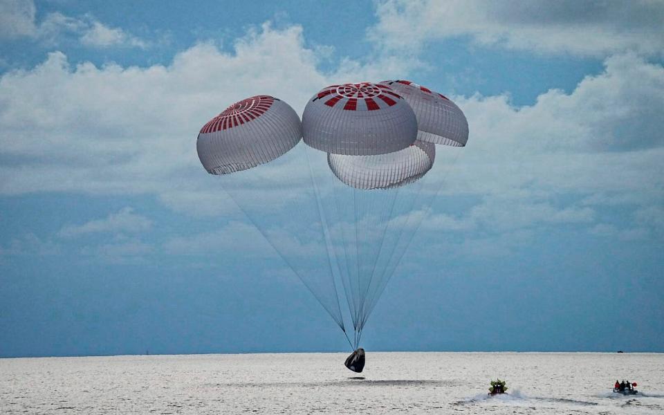 The capsule carrying four people parachutes into the Atlantic Ocean off the Florida coast - SpaceX