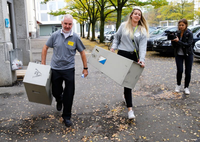 Members of the district election office Stadtkreis 3 carry ballot boxes in Zurich