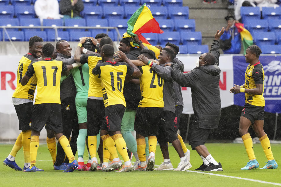 Ghana's players react after winning the match against Chile on penalties at the Kirin Cup soccer tournament in Suita, west Japan, Tuesday, June 14, 2022. (AP Photo/Eugene Hoshiko)