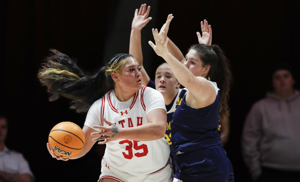 SALT LAKE CITY, UT – NOVEMBER 24: Alissa Pili #35 of the Utah Utes is pressured by Madison Roman #0 and Cadence Johnson #21 of the Merrimack Warriors during the first half of their game at the Jon M Huntsman Center on November 24, 2023 in Provo, Utah. (Photo by Chris Gardner/Getty Images)