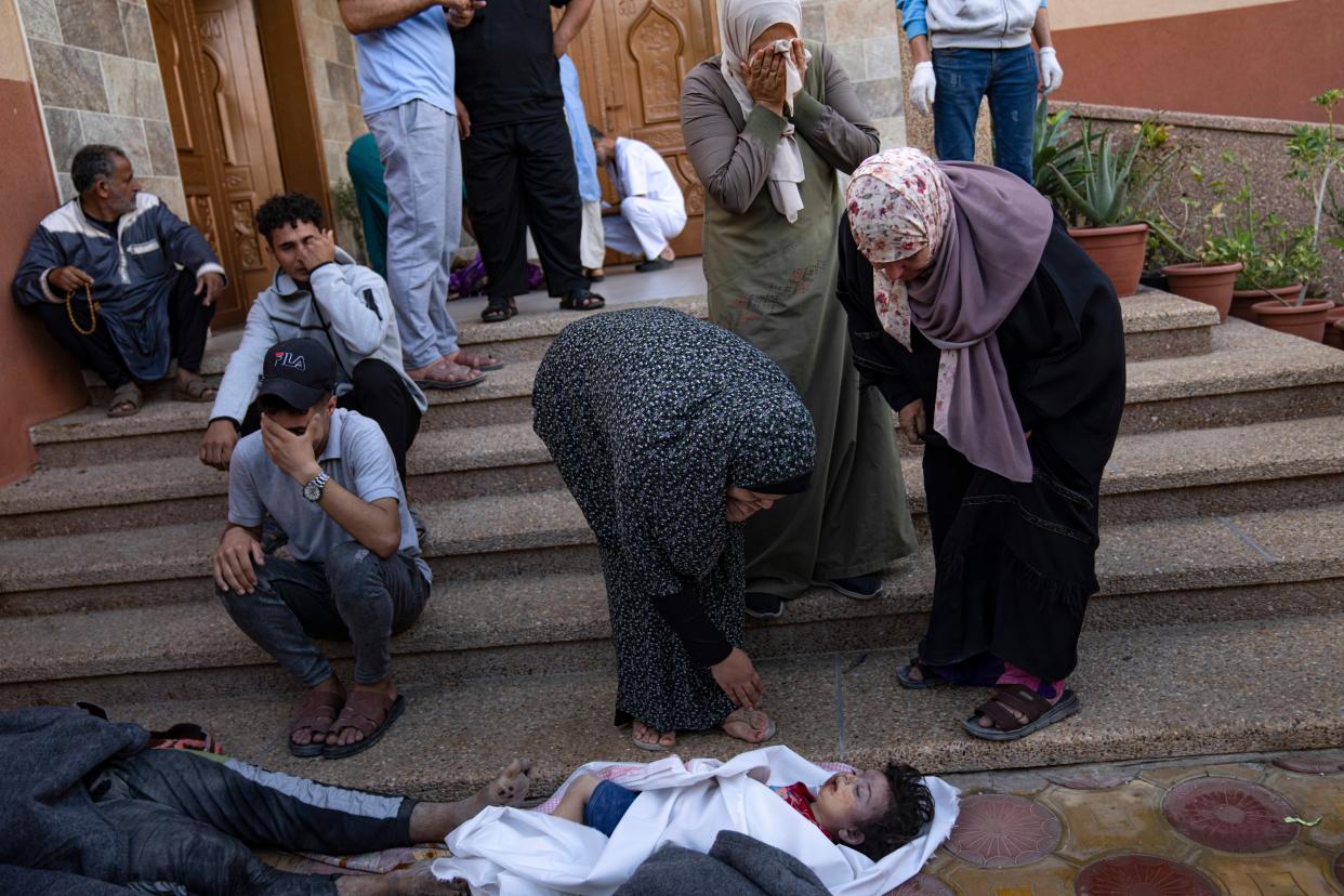 Palestinians mourn relatives killed in the Israeli bombardment of the Gaza Strip in a morgue in Khan Younis (Copyright 2023 The Associated Press. All rights reserved.)