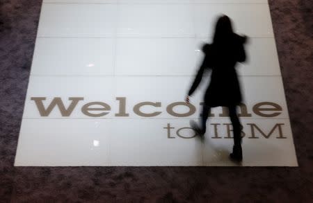 A woman walks over a welcoming sign at the booth of IBM at the CeBIT trade fair in Hanover March 15, 2015. REUTERS/Morris Mac Matzen