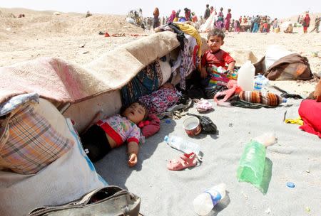 Sunni Muslims, who fled the Islamic State's strongholds of Hawija and Shirqat, rest after arriving at the town of Dibis, northwest of Kirkuk, Iraq, August 18, 2016. REUTERS/Ako Rasheed/File Photo