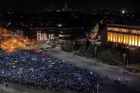 Romanians light up blue pieces of paper and pieces of yellow star shaped fabric thus forming the European Union flag during a protest against the government, in Bucharest, Romania, February 26, 2017. Inquam Photos/Octav Ganea/via REUTERS