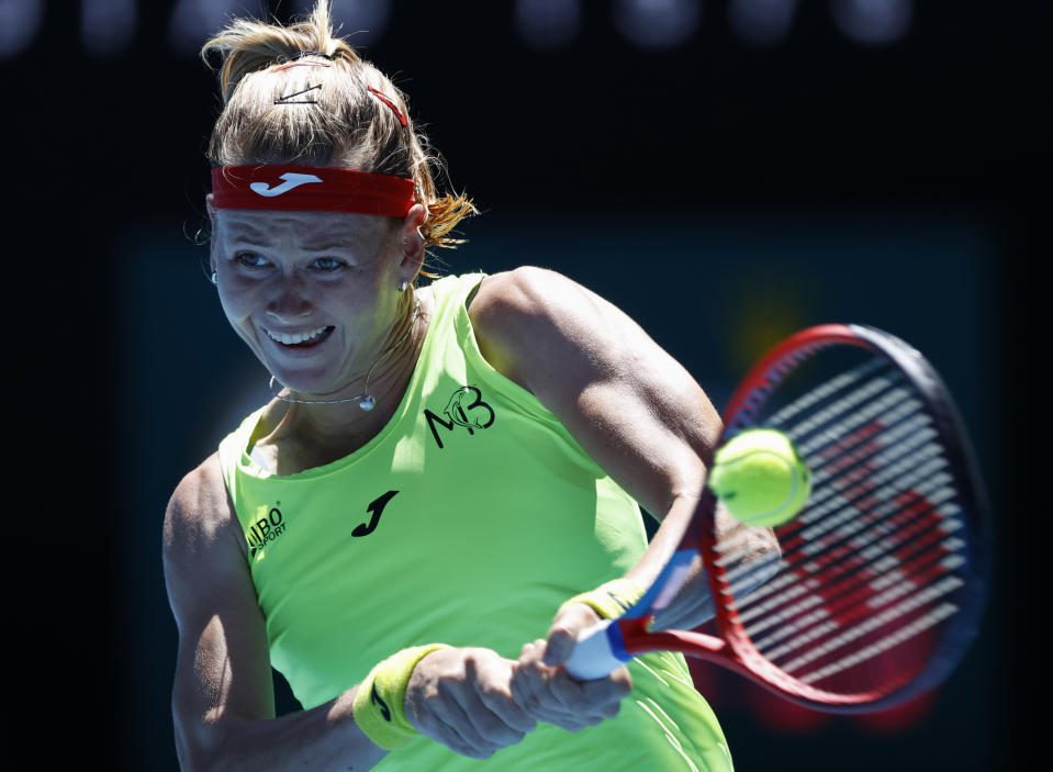Marie Bouzkova of the Czech Republic makes a backhand return to Ukraine's Elina Svitolina during their first round match at the Australian Open tennis championship in Melbourne, Australia, Tuesday, Feb. 9, 2021.(AP Photo/Rick Rycroft)
