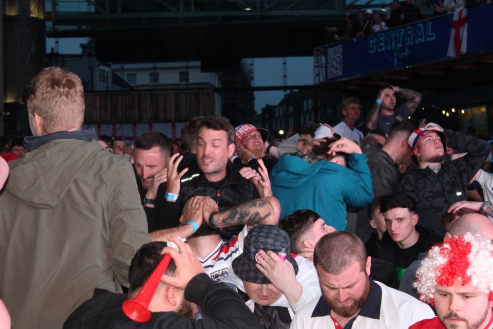 England fans hold their heads in their hands as they realise it’s all over (Tom Watling)