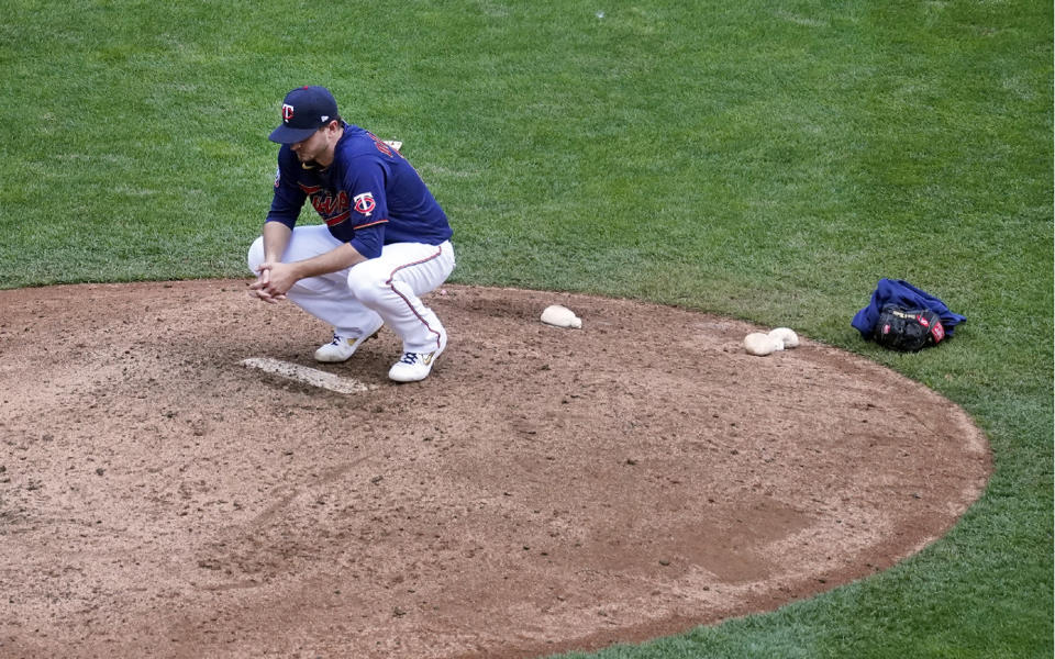 Minnesota Twins pitcher Jake Odorizzi spends a few moments alone on the mound after the 2020 season ended as the Twins lost the American League wild-card series to the Houston Astros, Wednesday, Sept. 30, 2020, in Minneapolis. The Astros beat them 3-1 in Game 2, Odorizzi did not pitch in the series. (AP Photo/Jim Mone)