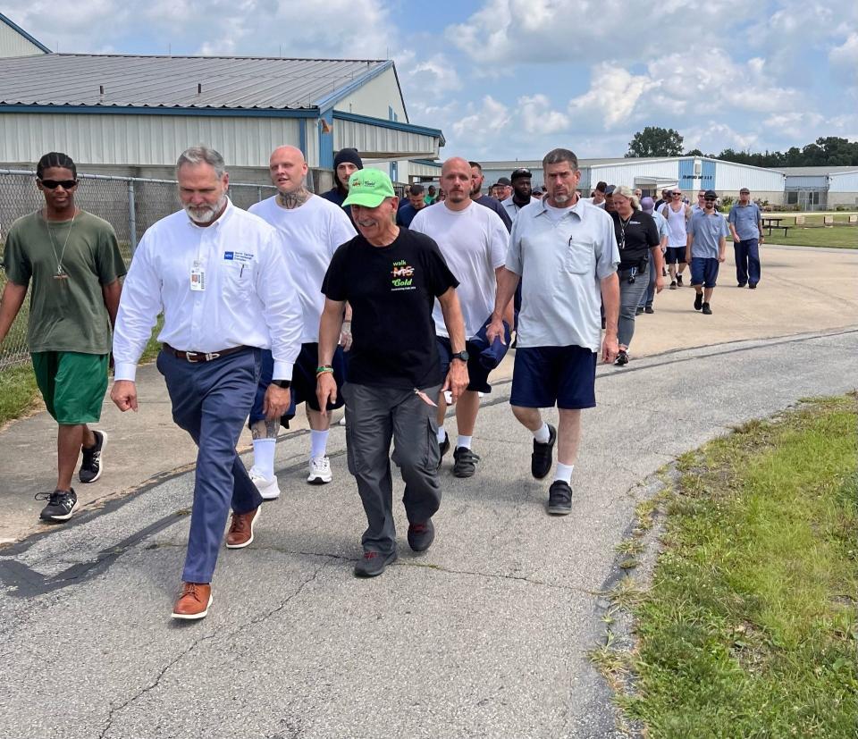 Warden T. Watson (left) and Tony Brigano lead staff and residents of North Central Correctional Complex in the walk to raise money for the Multiple Sclerosis Society.