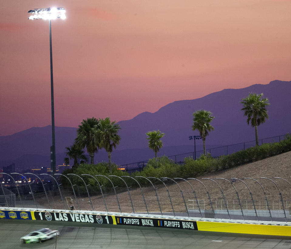The sun sets behind the mountains as Chase Briscoe drives during the NASCAR Xfinity Series auto race at Las Vegas Motor Speedway on Saturday, Sept. 26, 2020, in Las Vegas. Briscoe won the race. (Ellen Schmidt/Las Vegas Review-Journal via AP)