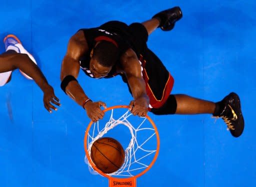 Chris Bosh of the Miami Heat dunks the ball against Serge Ibaka of the Oklahoma City Thunder in Game Two of the 2012 NBA Finals at Chesapeake Energy Arena, on June 14, in Oklahoma City, Oklahoma. The Heat won 100-96 to level the finals at one game apiece