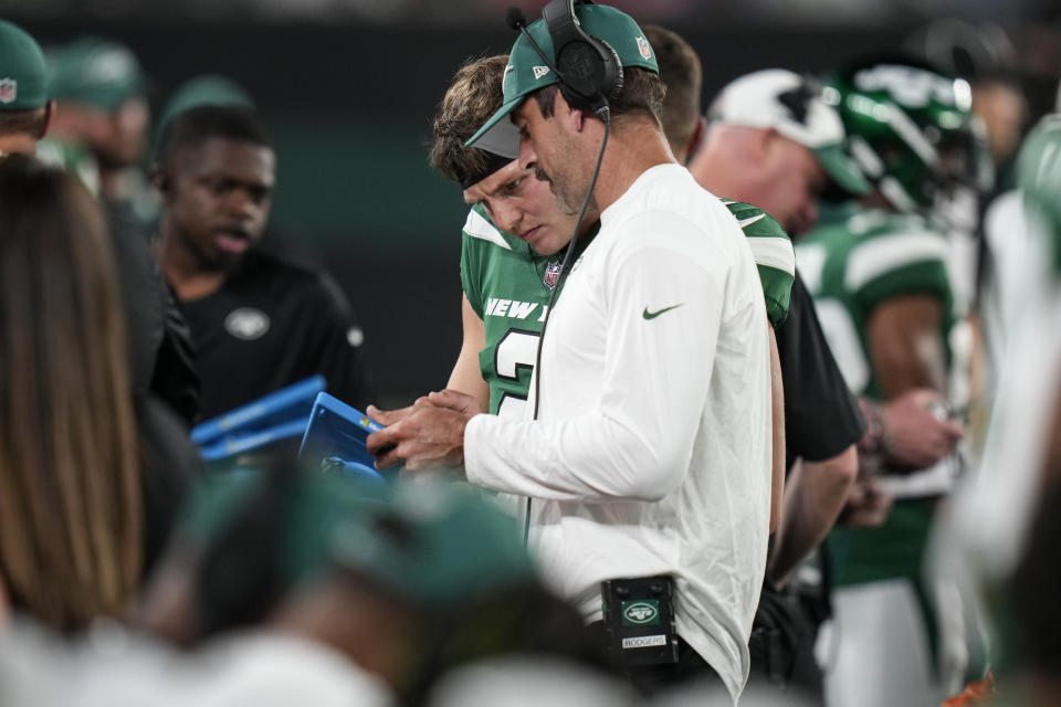 New York Jets quarterback Zach Wilson talks with Aaron Rodgers, right, during the first half of a preseason NFL football game against the Tampa Bay Buccaneers, Saturday, Aug. 19, 2023, in East Rutherford, N.J. (AP Photo/Seth Wenig)