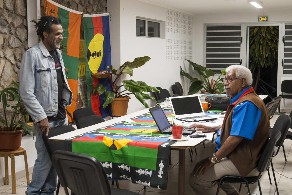 Pro-independentist leaders, Roch Wamytan right, and Jean-Louis Koroma, discuss as they wait for the official results of the independence referendum, at their headquarters in Noumea, the New Caledonia's capital, Sunday, Nov. 4, 2018. A majority of voters in the South Pacific territory of New Caledonia chose to remain part of France instead of backing independence, election officials announced Sunday as French President Emmanuel Macron promised a full dialogue on the region's future. (AP Photo/Mathurin Derel)