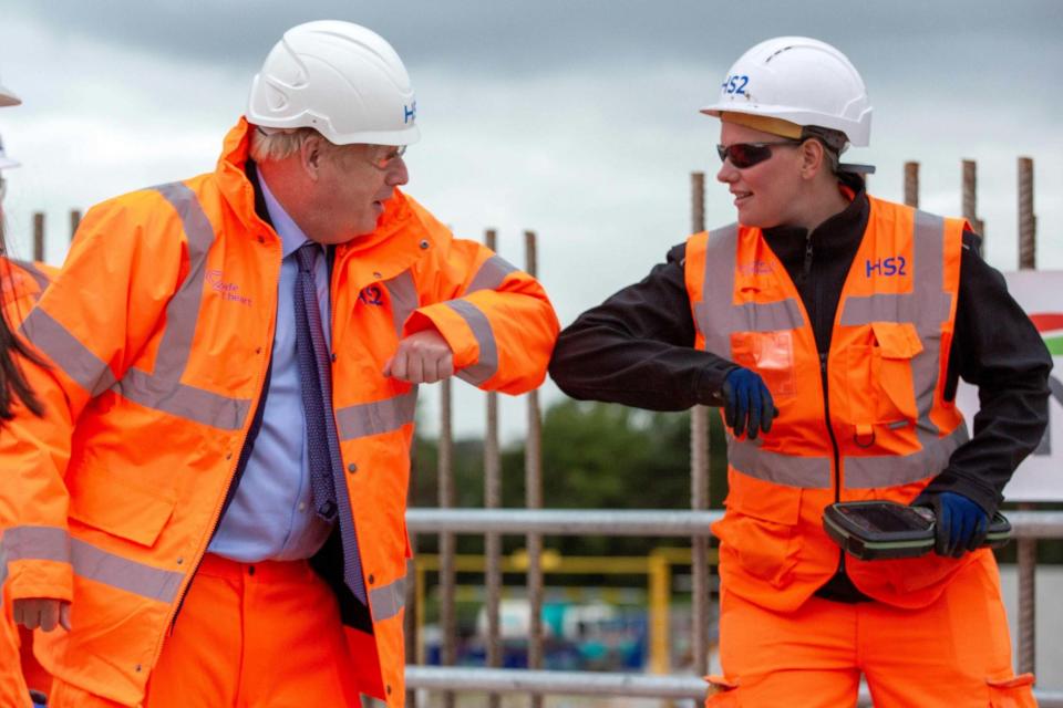 Boris Johnson greets a worker with an elbow bump (POOL/AFP via Getty Images)