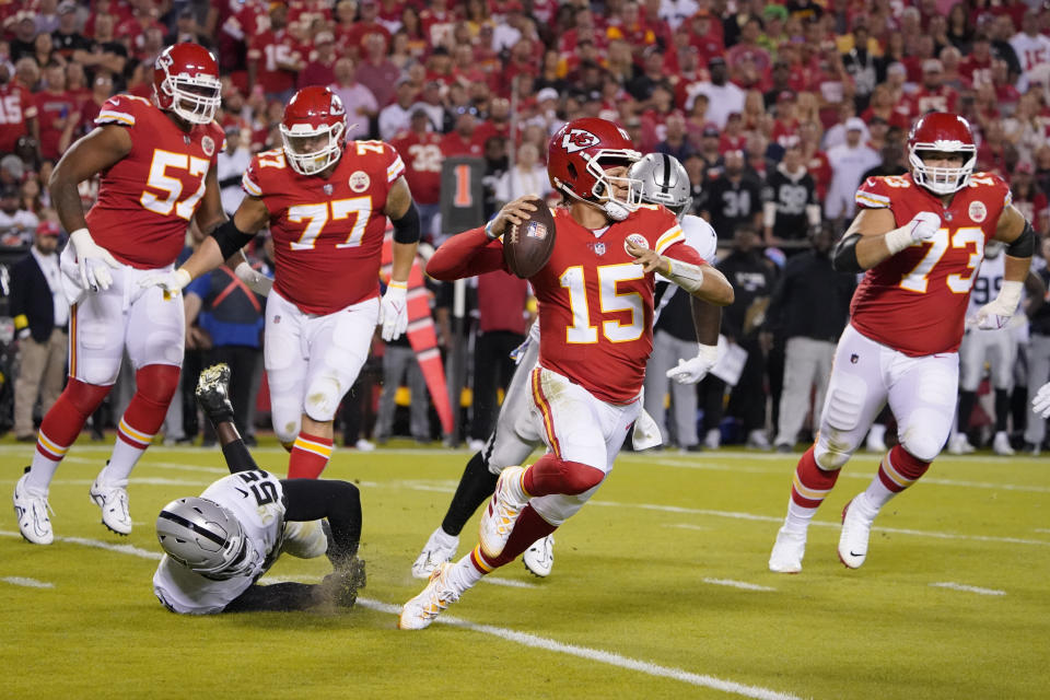 Kansas City Chiefs quarterback Patrick Mahomes (15) throws as he scrambles during the first half of an NFL football game against the Las Vegas Raiders Monday, Oct. 10, 2022, in Kansas City, Mo. (AP Photo/Ed Zurga)