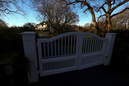 A house is seen past a gate on a property in East Hampton, New York, March 16, 2016. REUTERS/Jeffrey Basinger