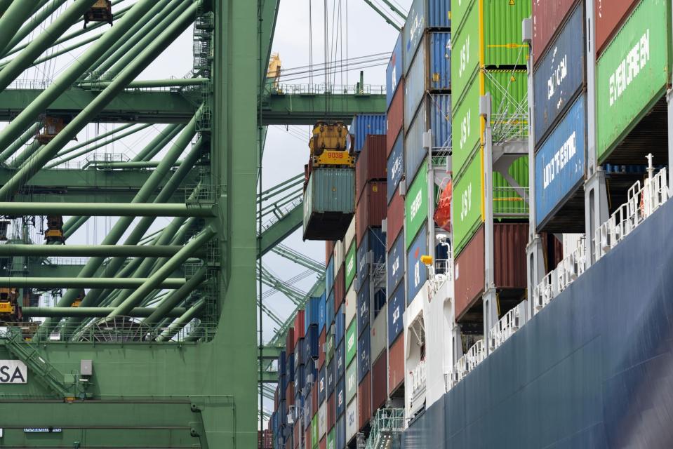 The CMA CGM Scandola container ship is simultaneously loaded with containers and bunkered with liquified natural gas (LNG) by the FueLNG Bellina bunkering vessel, not pictured, at the Port of Singapore in Singapore, on Wednesday, March 24, 2021. Photographer: Wei Leng Tay/Bloomberg