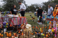 FILE - Sandra Cruz Torres, mother of Robb Elementary massacre victim Eliahna Torres, chats with Beto O'Rourke, Democratic candidate running for governor, as Cruz and her family celebrate Día de los Muertos at Torres' gravesite in Hillcrest Memorial Cemetery in Uvalde, Texas, Nov. 2, 2022. Sandra Cruz Torres filed a federal lawsuit on Monday, Nov. 28, against the police, the school district and the maker of the gun used in the massacre. (Sam Owens/The San Antonio Express-News via AP, File)