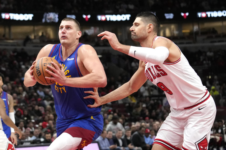 Denver Nuggets center Nikola Jokic drives to the basket past Chicago Bulls center Nikola Vucevic during the first half of an NBA basketball game Tuesday, Dec. 12, 2023, in Chicago. (AP Photo/Charles Rex Arbogast)