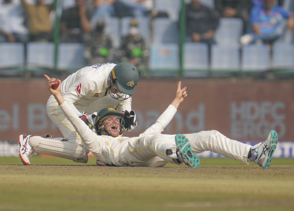 Australia's Peter Handscomb, foreground, celebrates after after catching out India's Shreyas Iyer during the second day of the second cricket test match between India and Australia in New Delhi, India, Saturday, Feb. 18, 2023. (AP Photo/Altaf Qadri)