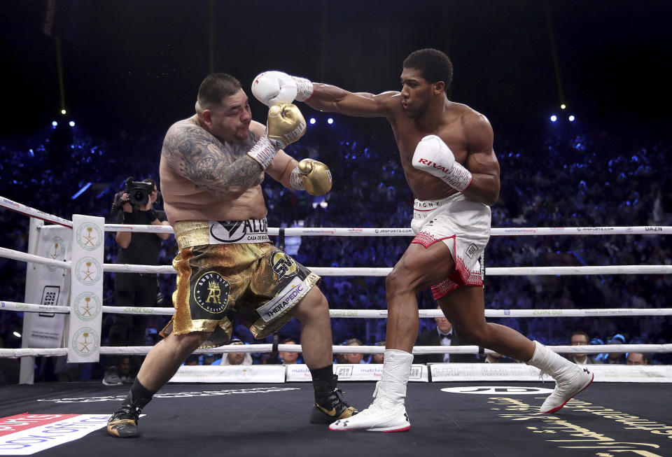 Defending champion Andy Ruiz Jr., left, during his fight against Britain's Anthony Joshua in their World Heavyweight Championship contest at the Diriyah Arena, Riyadh, Saudi Arabia. (Nick Potts/PA via AP)