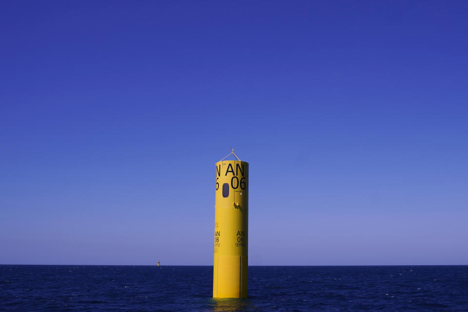 An installed monopile rises from the ocean at the South Fork Wind project, awaiting tower, turbine and blade sections, Tuesday, July 11, 2023, off the coast of Rhode Island. The trade association that represents the offshore service industry is going to great lengths to make sure that jobs go to Americans as the U.S. offshore wind industry ramps up. (AP Photo/Charles Krupa)