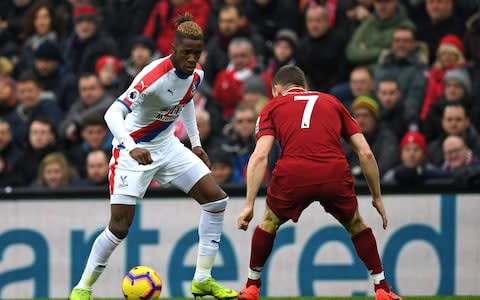 Crystal Palace's Ivorian striker Wilfried Zaha (L) vies with Liverpool's English midfielder James Milner during the English Premier League football match between Liverpool and Crystal Palace at Anfield in Liverpool, north west England on January 19, 2019. (Photo by Paul ELLIS / AFP) / RESTRICTED TO EDITORIAL USE. No use with unauthorized audio, video, data, fixture lists, club/league logos or 'live' services. Online in-match use limited to 120 images. An additional 40 images may be used in extra time. No video emulation. Social media in-match use limited to 120 images. An additional 40 images may be used in extra time. No use in betting publications, games or single club/league/player publications - Credit: AFP