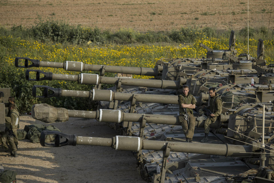 Israeli soldiers sit on top of mobile artillery near the border with Gaza, in southern Israel, Wednesday, March 27, 2019. (AP Photo/Tsafrir Abayov)