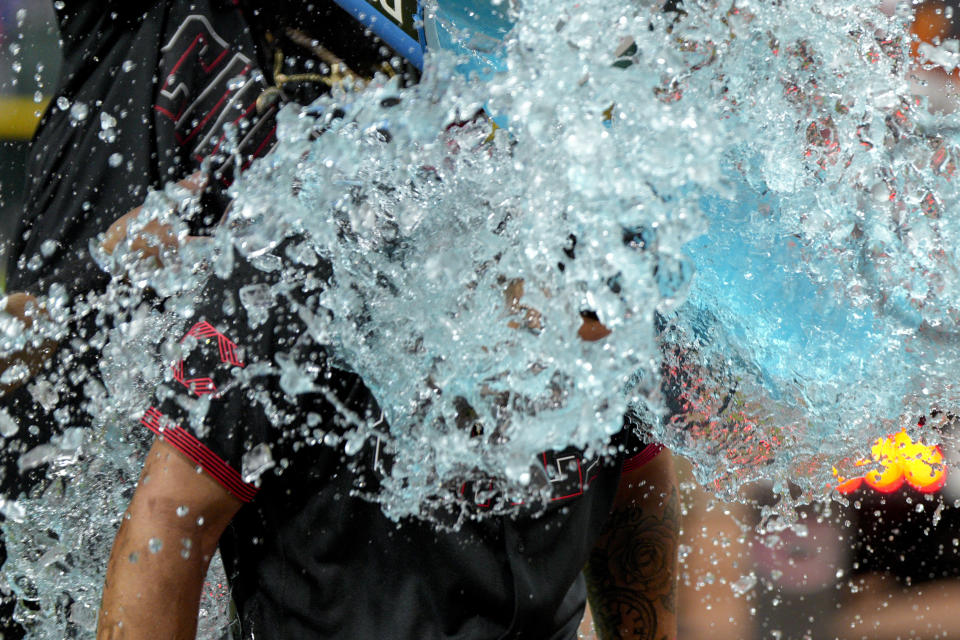 Cincinnati Reds' Christian Encarnacion-Strand is doused after hitting a walkoff home run against the Toronto Blue Jays in the ninth inning of a baseball game in Cincinnati, Friday, Aug. 18, 2023. (AP Photo/Jeff Dean)