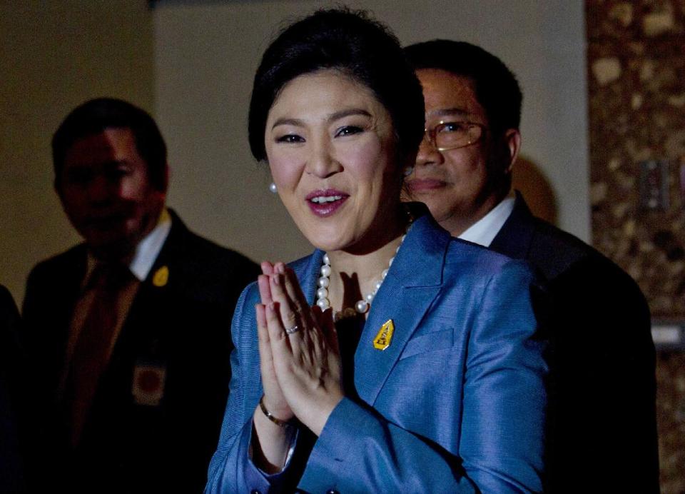 Thailand's Prime Minister Yingluck Shinawatra arrives at the Constitutional Court in Bangkok, Thailand, Tuesday, May 6, 2014. Yingluck defended herself Tuesday against abuse of power allegations in a crucial court case that is one of several legal challenges which could remove her from office. She is accused of abusing her authority by transferring her National Security Council chief in 2011 to another position. (AP Photo/Sakchai Lalit)