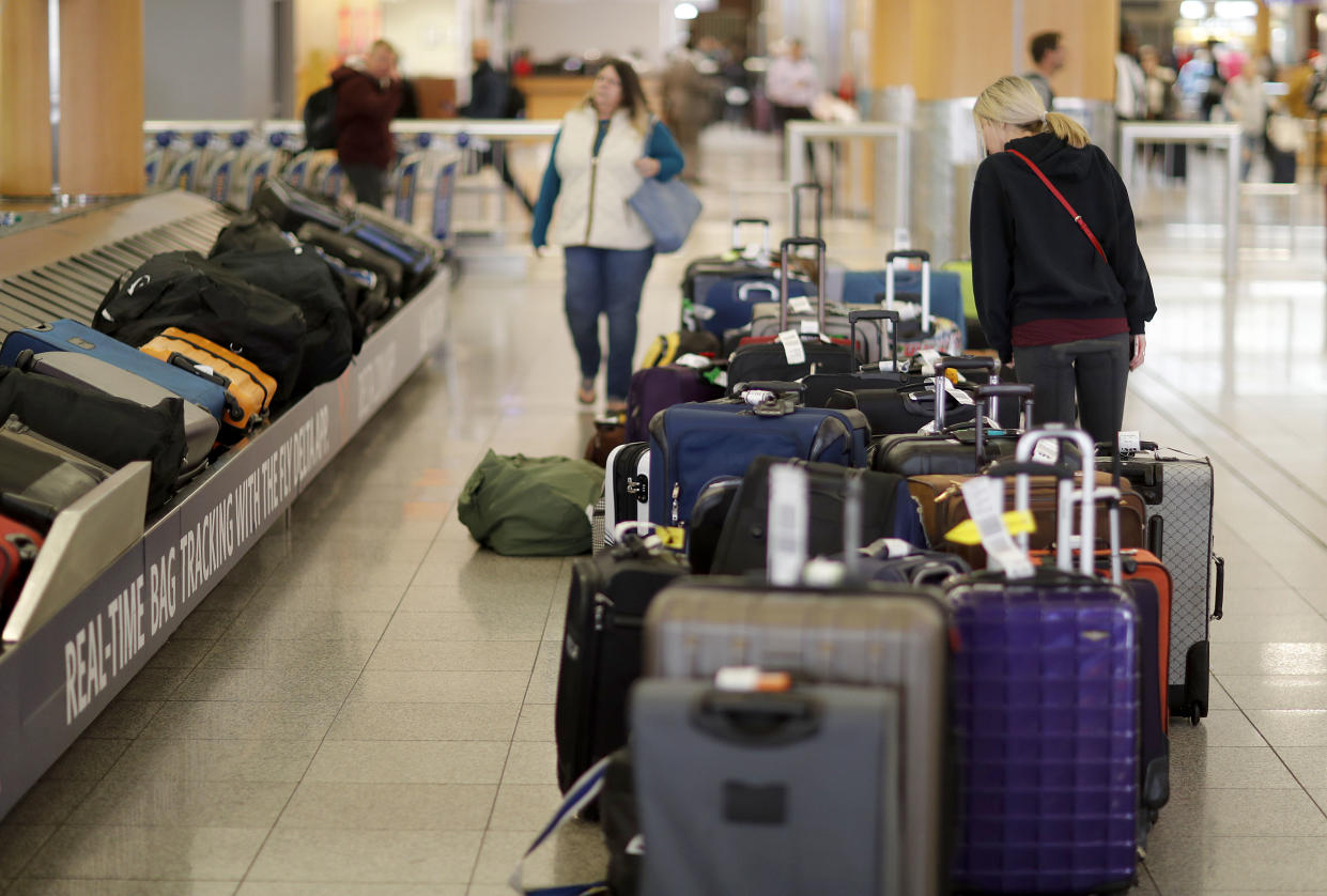 Unclaimed bags sit in baggage claim at Hartsfield-Jackson Atlanta International Airport in Atlanta, Monday, Dec. 18, 2017. While power was restored to the world's busiest airport early Monday, the travel woes will linger for days for the thousands of people stranded at Hartsfield-Jackson Atlanta International, where more than 1,000 flights were grounded just days before the start of the Christmas travel rush. (AP Photo/David Goldman)