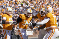 Tennessee tight end McCallan Castles (34) celebrates scoring a touchdown with teammates during the second half of an NCAA college football game against UConn, Saturday, Nov. 4, 2023, in Knoxville, Tenn. (AP Photo/Wade Payne)
