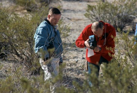 Handout photo of Apollo 11 astronauts Neil Armstrong and Buzz Aldrin document a geology sample during a field trip