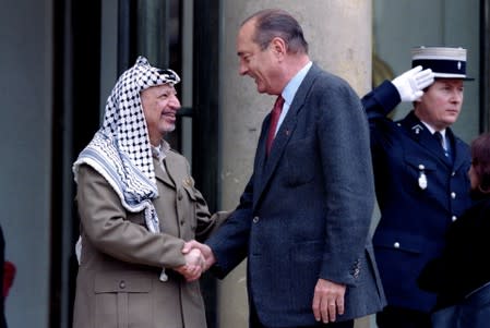 FILE PHOTO: File photo of PLO chairman Yasser Arafat greeted by French President Jacques Chirac as he arrives at the Elysee Palace in Paris