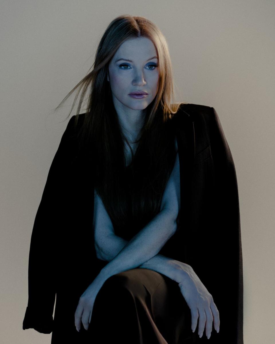 Jessica Chastain, shot under a blue-tinged light, sits for a portrait.