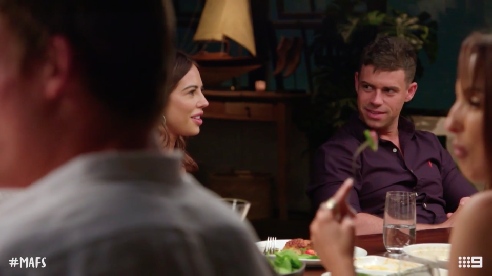 Michael looks at KC during a dinner party on MAFS