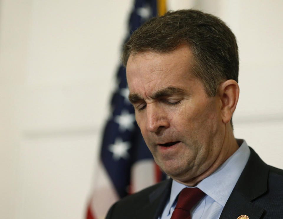 FILE - In this Feb. 2, 2019, file photo, Virginia Gov. Ralph Northam, pauses during a news conference in the Governors Mansion at the Capitol in Richmond, Va. Northam, a Democrat elected in a state that was once capital of the Confederacy, faced pressure to resign after a racist picture surfaced from his 1984 medical school yearbook in February. It showed a hard-to-identify young man in blackface standing beside someone dressed in a Ku Klux Klan costume. (AP Photo/Steve Helber, File)