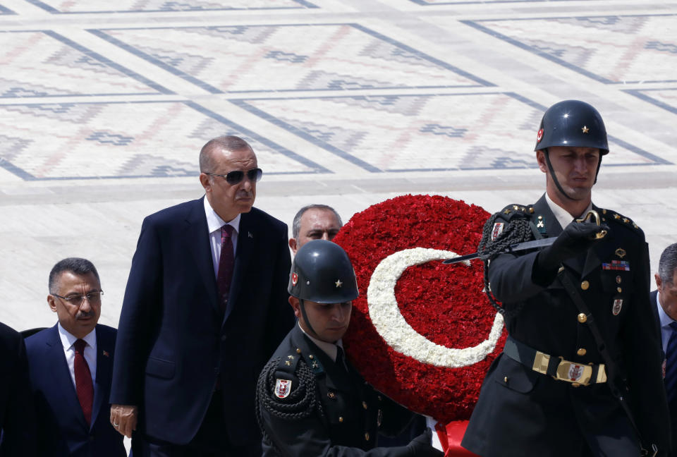 FILE - In this file photo dated Thursday, Aug. 1, 2019, Turkey's President Recep Tayyip Erdogan, center left, with ministers and army commanders as they follow a guard of honor at the mausoleum of Turkey's founder Mustafa Kemal Ataturk, in Ankara, Turkey. Turkey’s combative president is threatening to launch a military operation in northeastern Syria that would be designed to push back U.S.-allied Syrian Kurdish forces. (AP Photo/Burhan Ozbilici, FILE)