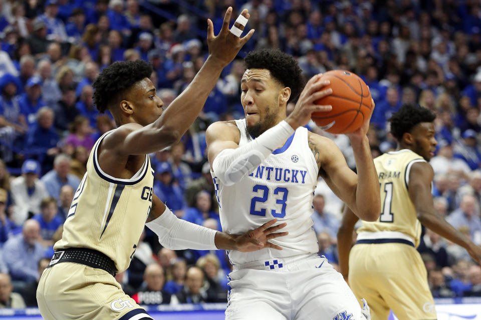 Kentucky's EJ Montgomery, right, looks for an opening on Georgia Tech's Khalid Moore, left, during the first half of an NCAA college basketball game in Lexington, Ky., Saturday, Dec. 14, 2019. (AP Photo/James Crisp)