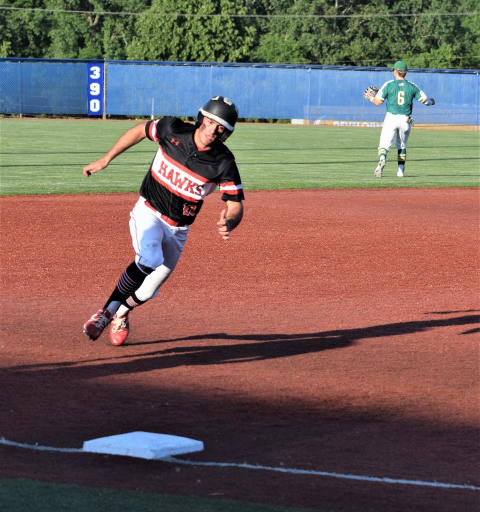 Nolan Yoder hits third and heads for home with Hiland's second run on a double by Alec Weaver. The Hawks came up one run short against Newark Catholic.